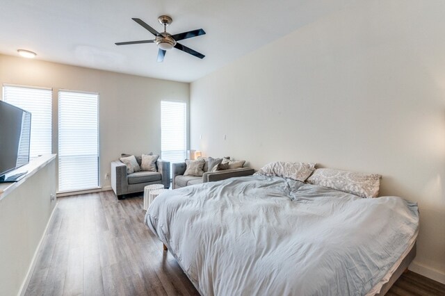3907 Throckmorton St Unit 4, Dallas, TX 75219 - bedroom with wood finished floors, baseboards, and a ceiling fan