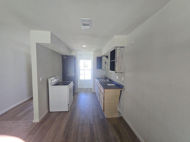 kitchen with washer / dryer, wood finished floors, baseboards, and white range with electric stovetop