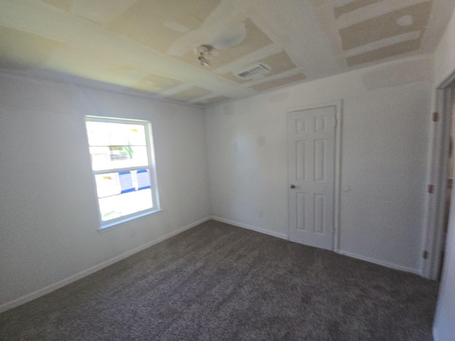 carpeted empty room featuring baseboards