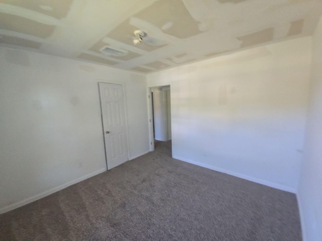 unfurnished room with carpet and baseboards