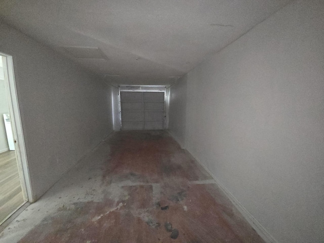 hallway with baseboards and wood finished floors