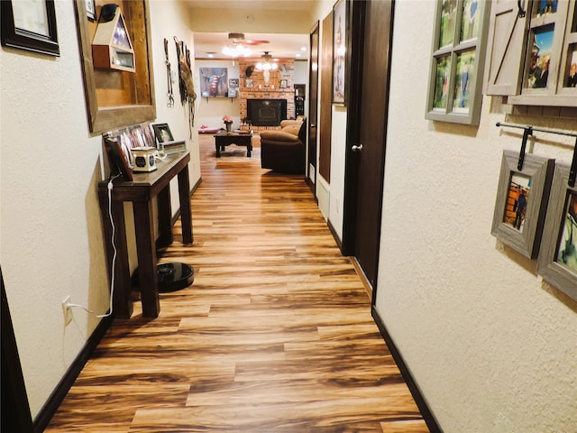 1630 County Road 3239, Hico, TX 76457 - corridor featuring a textured wall, light wood-type flooring, and baseboards