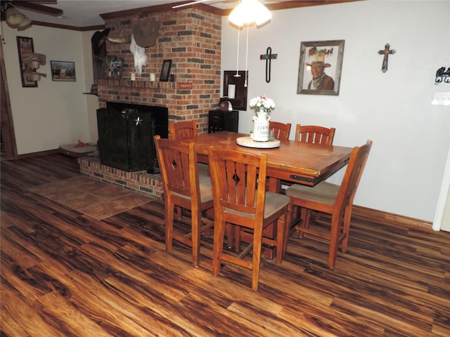 1630 County Road 3239, Hico, TX 76457 - dining area featuring a ceiling fan, wood finished floors, crown molding, baseboards, and a fireplace