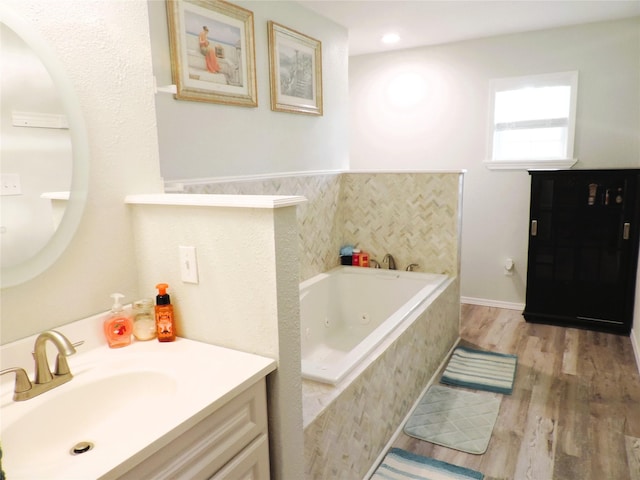 1630 County Road 3239, Hico, TX 76457 - full bathroom featuring a jetted tub, wood finished floors, and vanity