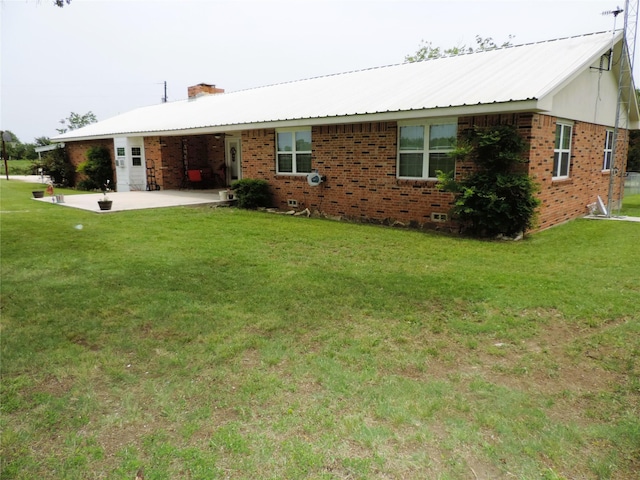 1630 County Road 3239, Hico, TX 76457 - rear view of house with brick siding, a chimney, a yard, and metal roof