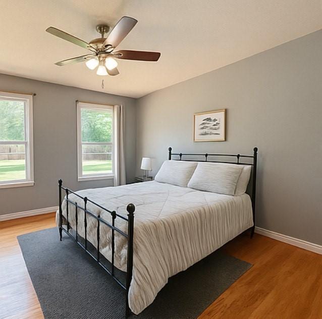 3124 Crest Ridge Dr, Dallas, TX 75228 - bedroom featuring multiple windows, light wood finished floors, and baseboards
