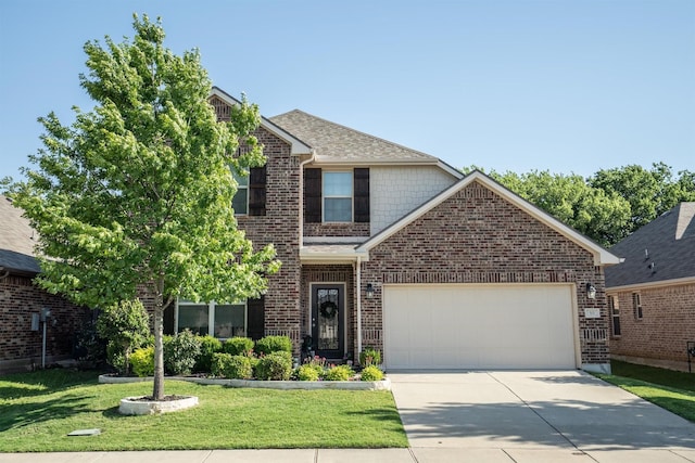 501 Bird Creek Dr, Little Elm, TX 75068 - traditional home featuring driveway, a front yard, a garage, brick siding, and roof with shingles
