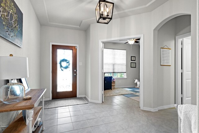 501 Bird Creek Dr, Little Elm, TX 75068 - entryway featuring light tile patterned floors, baseboards, a ceiling fan, a chandelier, and arched walkways