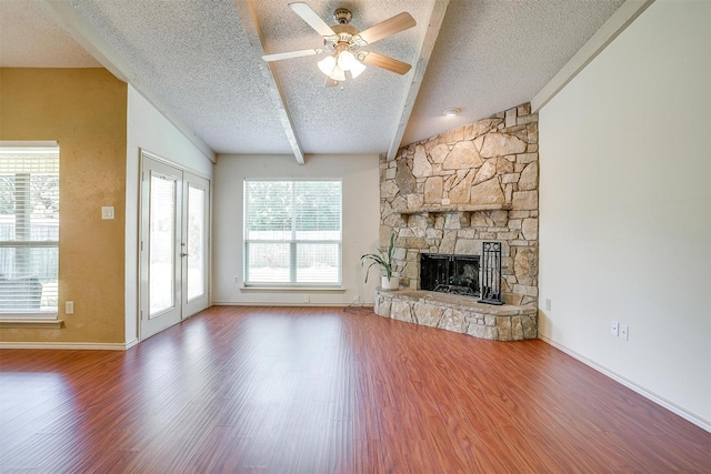 6436 Meadowlark Ln E, Watauga, TX 76148 - unfurnished living room featuring a textured ceiling, wood finished floors, a fireplace, ceiling fan, and baseboards