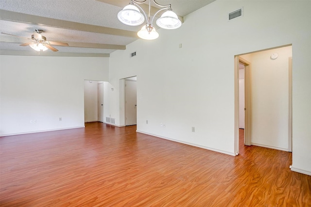 6436 Meadowlark Ln E, Watauga, TX 76148 - empty room with a ceiling fan, wood finished floors, a chandelier, high vaulted ceiling, and beamed ceiling