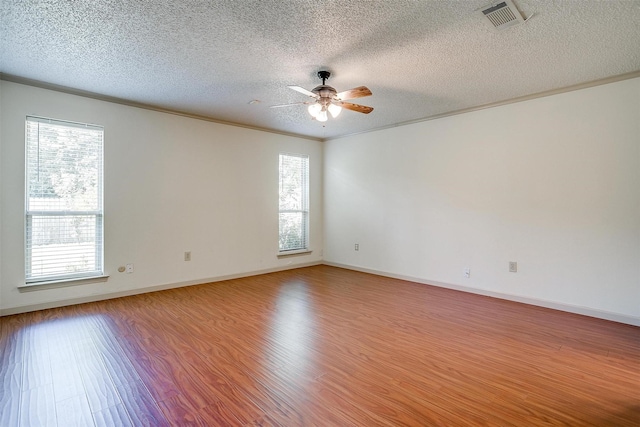 6436 Meadowlark Ln E, Watauga, TX 76148 - empty room with a textured ceiling, a ceiling fan, wood finished floors, baseboards, and ornamental molding