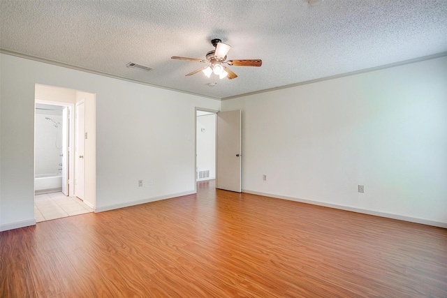 6436 Meadowlark Ln E, Watauga, TX 76148 - unfurnished room with light wood finished floors, a ceiling fan, a textured ceiling, and baseboards
