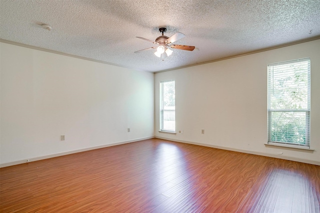 6436 Meadowlark Ln E, Watauga, TX 76148 - spare room featuring wood finished floors, a textured ceiling, a ceiling fan, crown molding, and a smoke detector