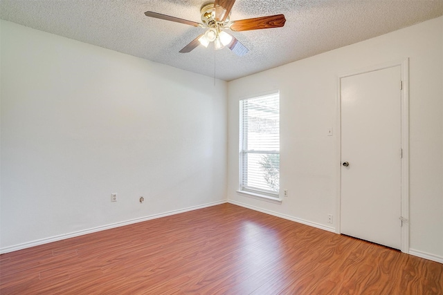 6436 Meadowlark Ln E, Watauga, TX 76148 - unfurnished room with a textured ceiling, wood finished floors, ceiling fan, and baseboards