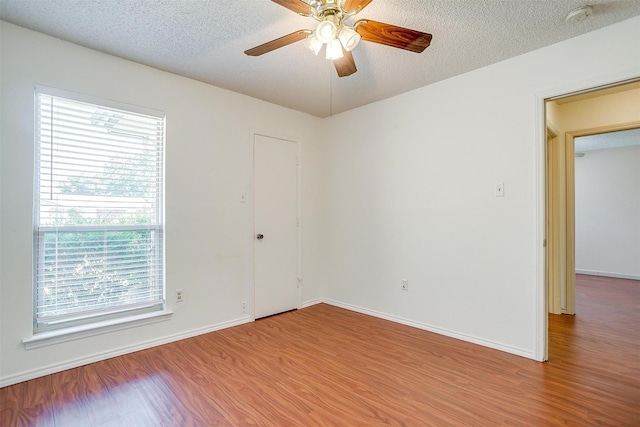 6436 Meadowlark Ln E, Watauga, TX 76148 - unfurnished room with a smoke detector, wood finished floors, baseboards, and a textured ceiling