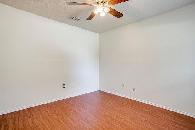 6436 Meadowlark Ln E, Watauga, TX 76148 - empty room with ceiling fan, wood finished floors, a textured ceiling, and baseboards