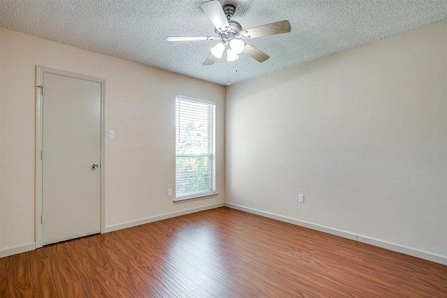 6436 Meadowlark Ln E, Watauga, TX 76148 - empty room with wood finished floors, a ceiling fan, a textured ceiling, and baseboards