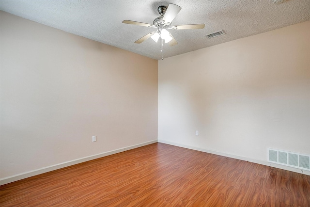 6436 Meadowlark Ln E, Watauga, TX 76148 - empty room with wood finished floors, baseboards, a ceiling fan, and a textured ceiling