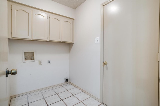 6436 Meadowlark Ln E, Watauga, TX 76148 - laundry area with cabinet space, electric dryer hookup, hookup for a washing machine, light tile patterned floors, and a textured ceiling