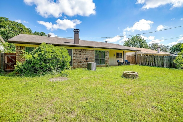 6436 Meadowlark Ln E, Watauga, TX 76148 - rear view of property with a fire pit, brick siding, cooling unit, and a chimney