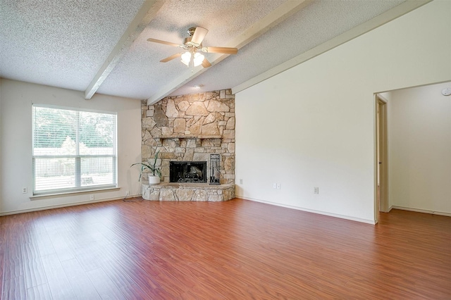 6436 Meadowlark Ln E, Watauga, TX 76148 - unfurnished living room with a textured ceiling, wood finished floors, ceiling fan, and a fireplace