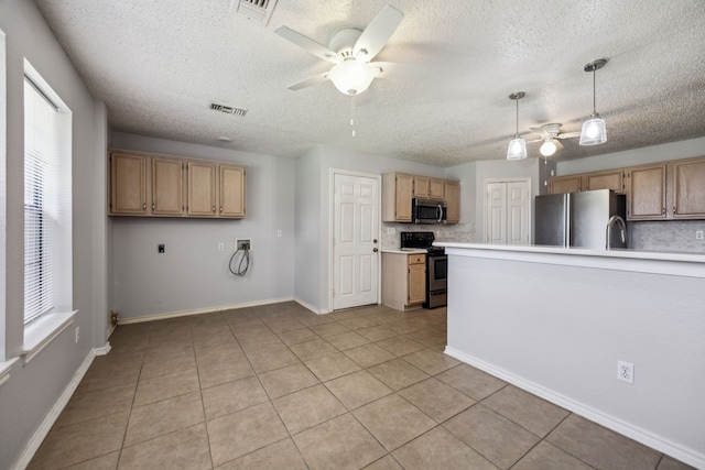 kitchen with stainless steel appliances, ceiling fan, light countertops, a textured ceiling, and light tile patterned floors
