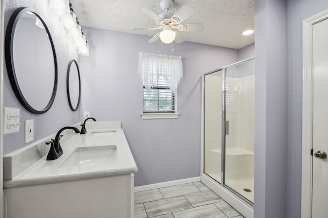 full bath featuring a shower stall, ceiling fan, a textured ceiling, marble finish flooring, and baseboards