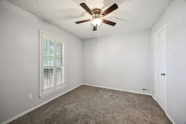 carpeted spare room with a textured ceiling, a ceiling fan, and baseboards