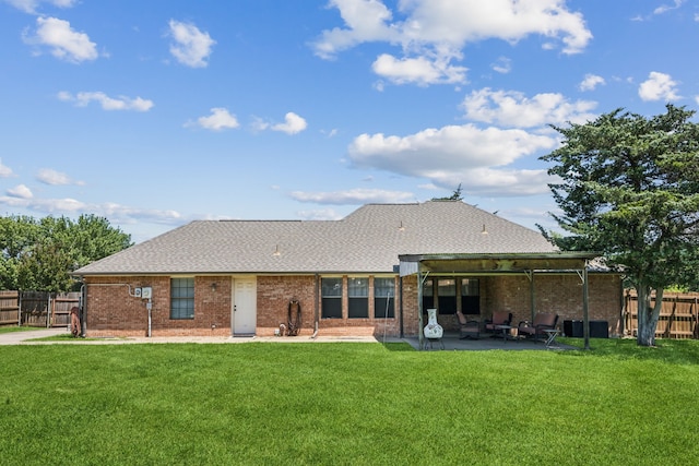back of property featuring a patio, brick siding, and roof with shingles