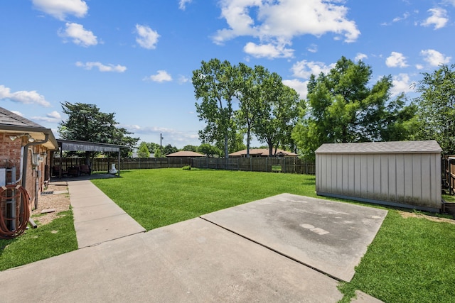 view of yard featuring a patio, a storage shed, and an outbuilding