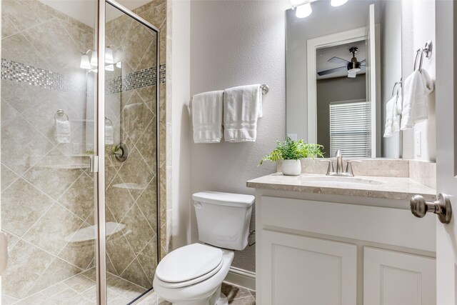 2205 Grafton Ln, Mckinney, TX 75071 - bathroom with toilet, vanity, a shower stall, a textured wall, and baseboards