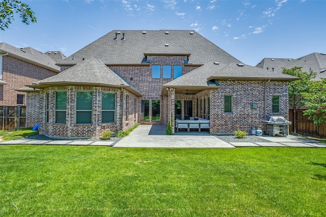 2205 Grafton Ln, Mckinney, TX 75071 - rear view of house with brick siding, a patio, and roof with shingles