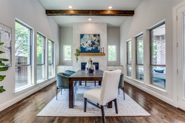 2205 Grafton Ln, Mckinney, TX 75071 - dining area with healthy amount of natural light, beam ceiling, a fireplace, dark wood-style flooring, and baseboards