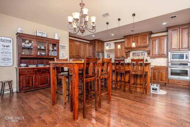 4549 Coyote Run, Abilene, TX 79602 - dining area with dark wood-type flooring, a chandelier, and recessed lighting