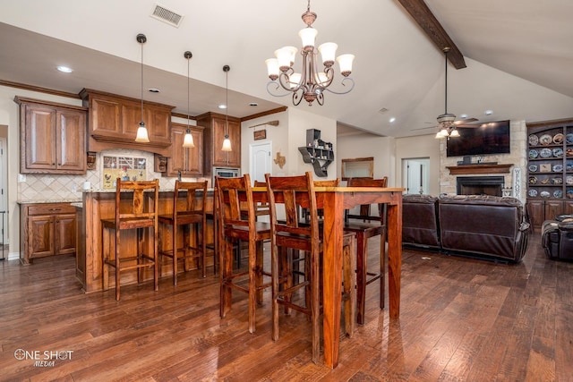 4549 Coyote Run, Abilene, TX 79602 - dining room with a ceiling fan, dark wood-type flooring, a chandelier, a fireplace, and recessed lighting