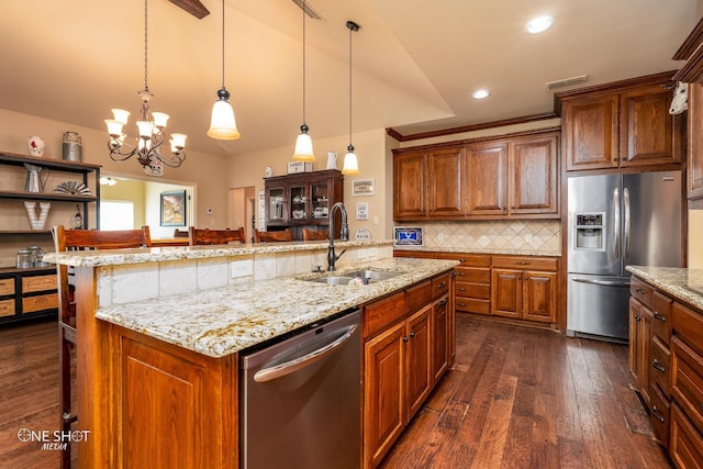 4549 Coyote Run, Abilene, TX 79602 - kitchen with appliances with stainless steel finishes, a sink, dark wood finished floors, a chandelier, and an island with sink