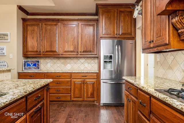 4549 Coyote Run, Abilene, TX 79602 - kitchen with stainless steel appliances, decorative backsplash, light stone counters, crown molding, and dark wood-type flooring