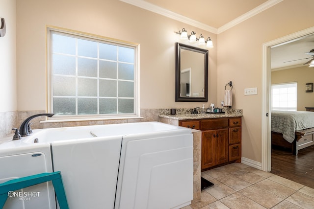 4549 Coyote Run, Abilene, TX 79602 - bathroom featuring crown molding, ensuite bathroom, a garden tub, and vanity