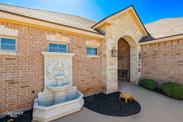 4549 Coyote Run, Abilene, TX 79602 - view of exterior entry featuring a shingled roof and brick siding