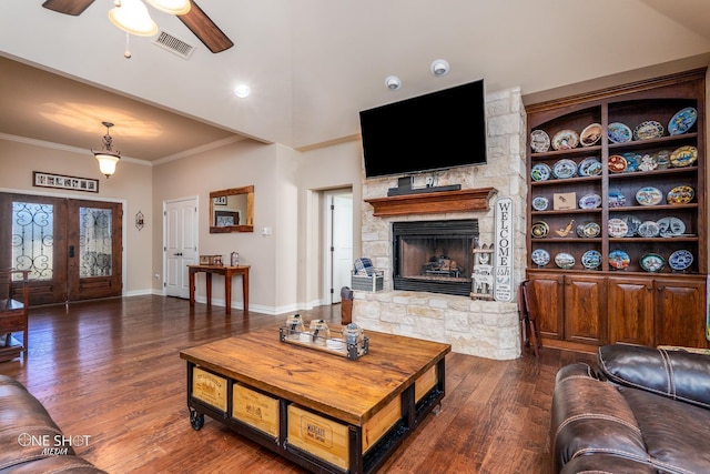 4549 Coyote Run, Abilene, TX 79602 - living room featuring crown molding, ceiling fan, dark wood-type flooring, a fireplace, and baseboards