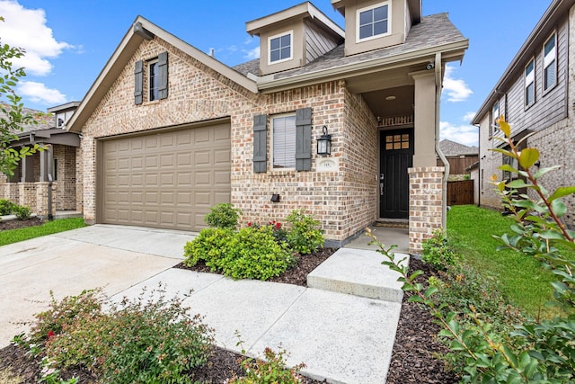 3952 Oak Creek Cir, Denison, TX 75020 - view of front of property featuring brick siding, driveway, a garage, and a shingled roof