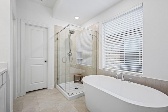 3952 Oak Creek Cir, Denison, TX 75020 - bathroom with a soaking tub, a stall shower, tile patterned floors, and vanity