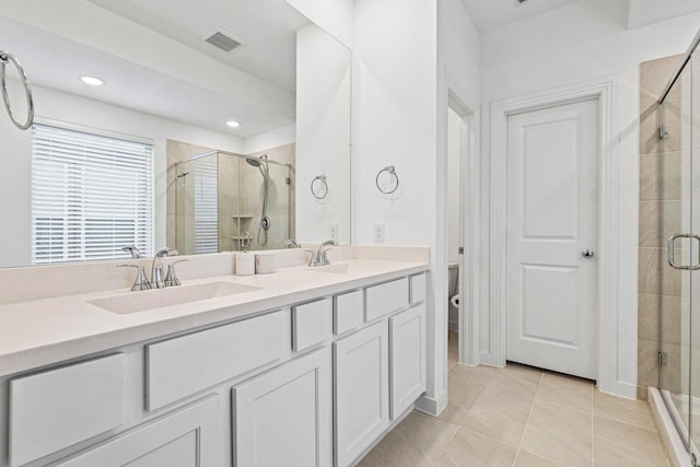 3952 Oak Creek Cir, Denison, TX 75020 - full bathroom featuring a shower stall, double vanity, tile patterned flooring, toilet, and recessed lighting