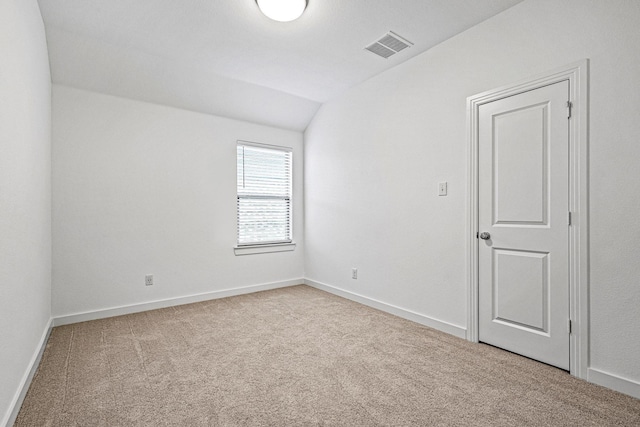 3952 Oak Creek Cir, Denison, TX 75020 - unfurnished room featuring vaulted ceiling, carpet flooring, and baseboards