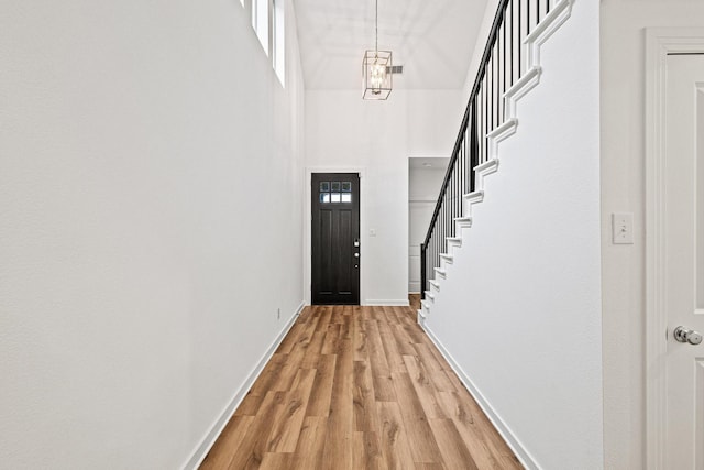 3952 Oak Creek Cir, Denison, TX 75020 - doorway with a high ceiling, light wood-type flooring, baseboards, and stairway