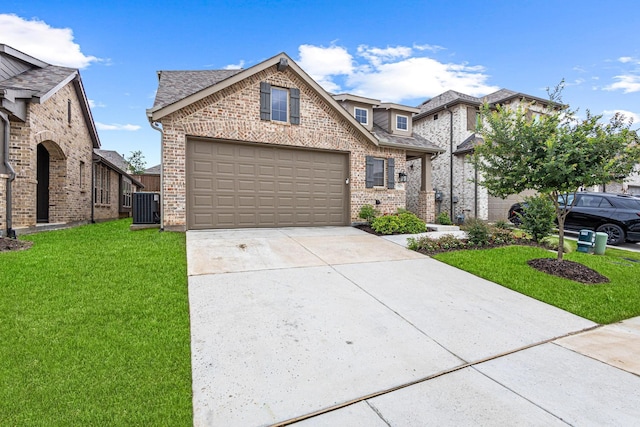 3952 Oak Creek Cir, Denison, TX 75020 - view of front of property featuring brick siding, cooling unit, a front yard, and driveway