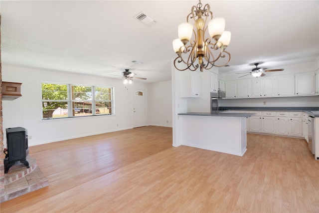 125 Harrison, Detroit, TX 75436 - kitchen with a ceiling fan, dark countertops, white cabinets, and light wood-style flooring