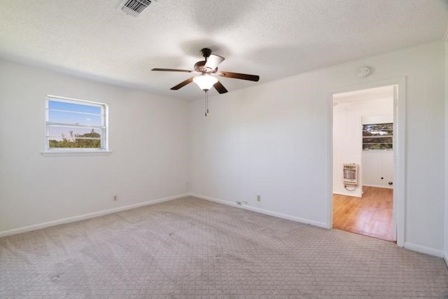 125 Harrison, Detroit, TX 75436 - empty room with a ceiling fan, carpet flooring, heating unit, a textured ceiling, and baseboards