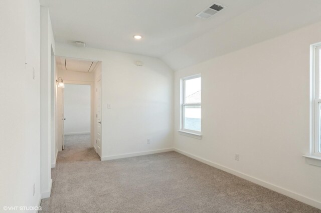 carpeted empty room featuring attic access, baseboards, lofted ceiling, and recessed lighting
