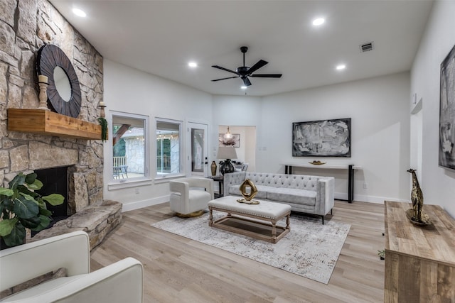 375 Briarwood Ln, Aledo, TX 76008 - living room featuring a stone fireplace, a ceiling fan, light wood-type flooring, baseboards, and recessed lighting
